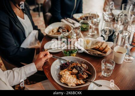 Young businessman having food with colleagues in hotel Stock Photo