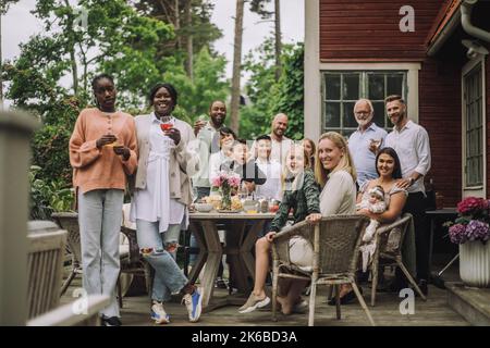 Portrait of multi-generation family during birthday celebration on porch Stock Photo