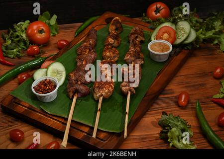 Grilled meat with Sichuan pepper on wood board and ingredients. Mala, Sichuan pepper, Chinese spices Stock Photo