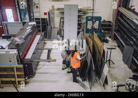 High angle view of female colleagues working together in workshop Stock Photo
