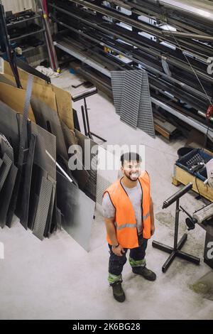 High angle view of happy young male carpenter working in workshop Stock Photo