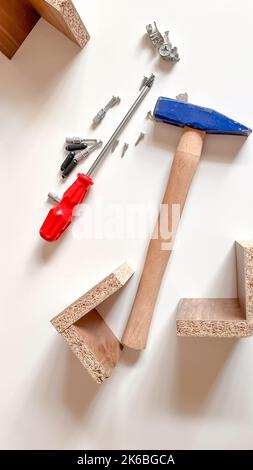 Mechanic tools set on white. Fixing equipment isolated on white background. Blue hammer, red screwdriver, piece of woods and screws Stock Photo