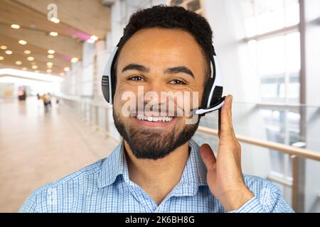 Corporate Professional Call Centre Agent with headphones on his head Stock Photo