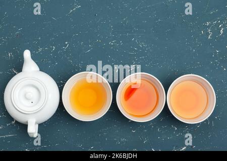 Collection of different teas in cups with tea leaves Stock Photo