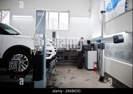 Auto mechanic sets american SUV car for diagnostics and configuration