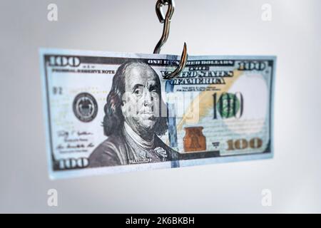 Money on the hook. Hooked on dollars idea creative photo. Financial concept for loans or some other money trap. dependence on the dollar concept Stock Photo