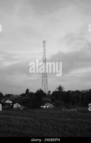 Monochrome photo, view of signal tower and electricity distribution tower, Cikancung - Indonesia Stock Photo