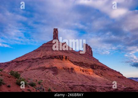 First light at sunrise on the talus slope below the Castleton Tower / Castle Rock near Moab, Utah.  The Rectory is behind. Stock Photo