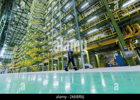 Dortmund, Germany. 13th Oct, 2022. An employee walks in the new hot-dip coating line (FBA 10) on the Thyssenkrupp-Westfalenhütte site. With this investment the company is strengthening its position as Germany's leading flat steel producer. Credit: Rolf Vennenbernd/dpa/Alamy Live News Stock Photo