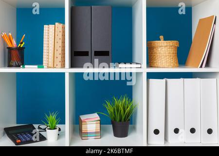 White office shelves with different stationery, close up Stock Photo