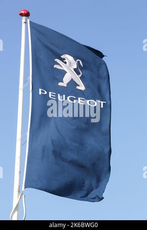 Risskov, Denmark - May 11, 2019: Peugeot logo on a flag. Peugeot is a French cars brand, part of PSA Peugeot Citroen group Stock Photo