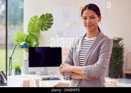 Portrait Of Female Architect Standing In Office With Folded Arms Stock Photo