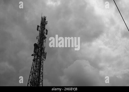 Monochrome photo, view of signal tower and electricity distribution tower, Cikancung - Indonesia Stock Photo