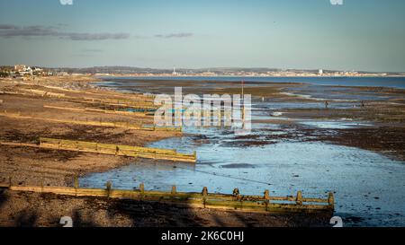 A view eastwards at low tide down Worthing beach in West Sussex, UK, towards Littlehampton, Shoreham and Brighton Stock Photo