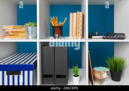 White office shelves with different stationery, close up Stock Photo