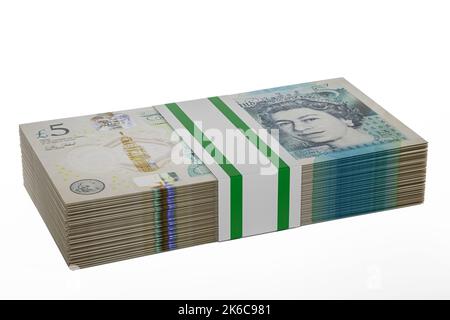 pile piles of UK money stack stacks of british polymer £5 notes bundle bundles of five pound banknotes Stock Photo