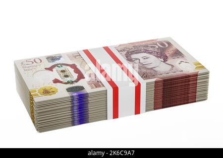 pile piles of UK money stack stacks of British polymer £50 notes bundle bundles of fifty pound banknotes Stock Photo