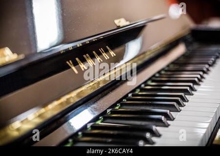 A closeup shot of the keys on an acoustic U2 Yamaha black piano Stock Photo