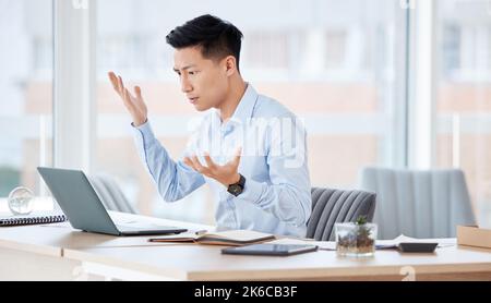 Nothing seems to be going right. a young businessman looking confused while working in an office. Stock Photo