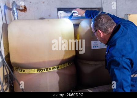 Schwerin, Germany. 10th Oct, 2022. Günter M. checks the filling of heating oil tanks in the cellar of a private house. With rising energy prices, the cost of heating oil has also increased significantly. Credit: Jens Büttner/dpa/Alamy Live News Stock Photo
