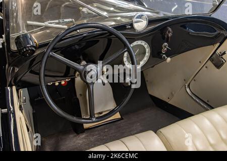 Steering wheel with dashboard in the interior of a sport-style vintage car Stock Photo