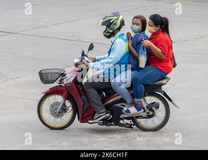 SAMUT PRAKAN, THAILAND, OCT 03 2022, A pair of women ride a moto taxi Stock Photo