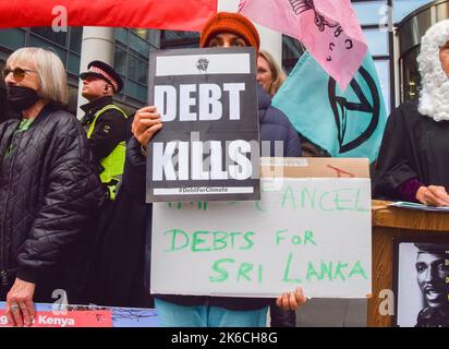 London, England, UK. 13th Oct, 2022. A protester calls for Sri Lanka's debts to be cancelled. Protesters gathered outside the World Bank's London office demanding that IMF and World Bank cancel the debts of the Global South for climate justice. (Credit Image: © Vuk Valcic/ZUMA Press Wire) Stock Photo