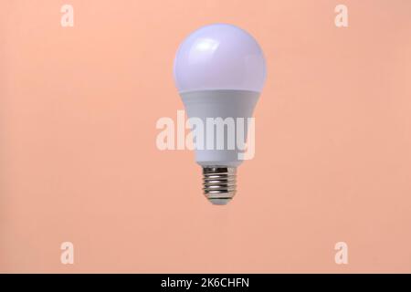 LED eco light bulb on beige background Stock Photo