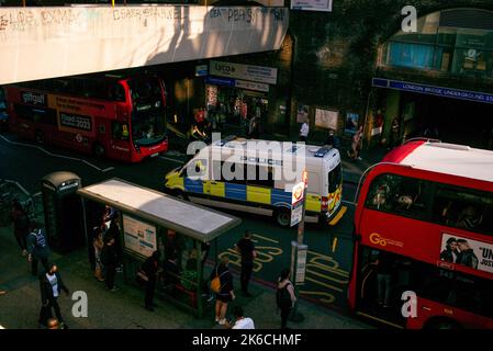 A police van works its way through the traffic and London Buses at London Bridge Underground station.Viewed from above. Duke street hill. Stock Photo