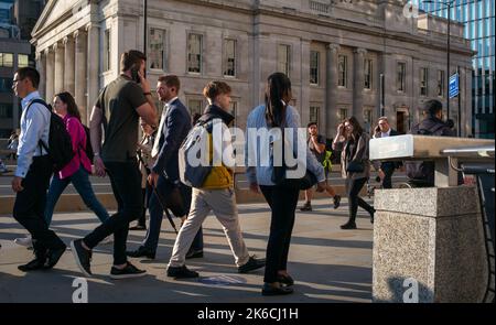 A view on to London Bridge from London Bridge Wharf stairs as people walk by in evening rush hour. Stock Photo