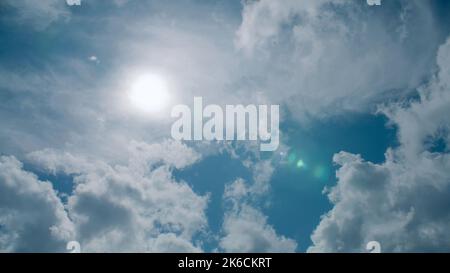 Bright sun's rays floating in a deep sea of clouds, beautiful sunny pastel unfolding across the sky. Amazing loveliness of nature scenery, warm of summer sunrise Stock Photo