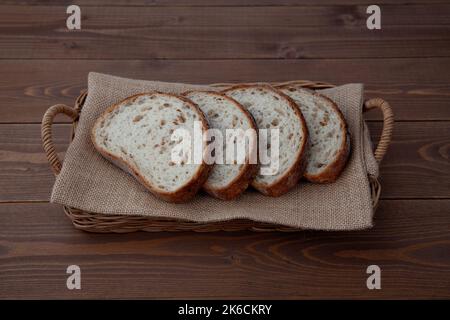 sliced rye bread isolated on wooden table Stock Photo
