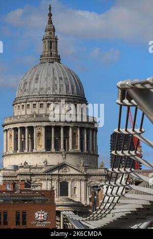 Close-up telephoto shot of St Paul's Cathedral with the line of Millennium bridge leading towards it in the foreground. Stock Photo