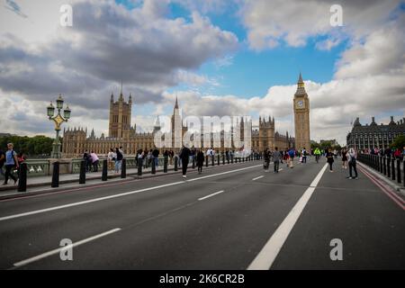 Houses of Parliament seen from Westminster bridge which is shut to traffic so people can walk on the road giving an unusual view. Stock Photo