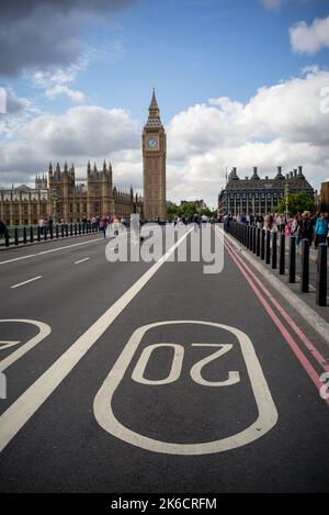 A view from the road on Westminster Bridge showing the 20mph signs and a traffic free road with public waling on road during closure. Stock Photo