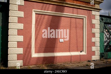 A London wall part of Hungerford Bridge with an anti graffiti sign on a freshly painted wall. Stock Photo