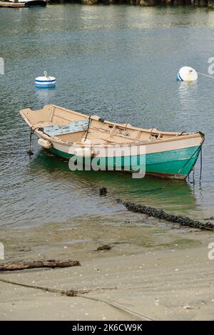 classic vintage wood boat beached on the sand Stock Photo