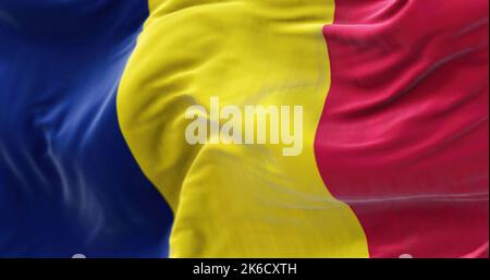 Close-up view of the Chad national flag waving in the wind. The Republic of Chad is a country at the crossroads of North and Central Africa. Fabric te Stock Photo