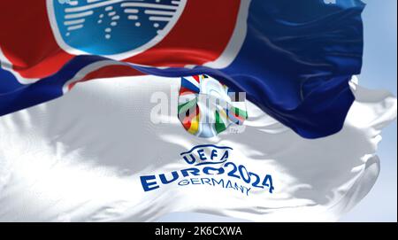 Berlin, Ger, October 2022: UEFA and UEFA Euro 2024 flags flying in the wind. The 17th edition will take place from 14 June to 14 July 2024 in Germany. Stock Photo