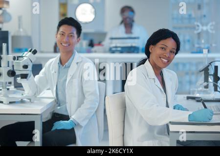 Working together to change the future. two lab workers together in their office. Stock Photo