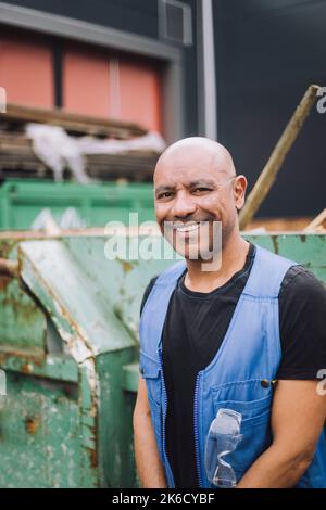 Happy bald mature construction worker at site Stock Photo