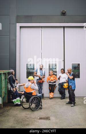 Male and female construction worker discussing with each other at site Stock Photo