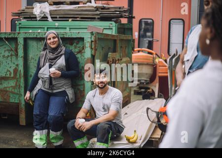Male and female colleagues discussing during break at site Stock Photo