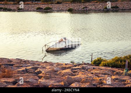 old small boat sunk in the river and abandoned Stock Photo