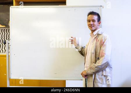 Adult Education: Art Class. An art teacher addressing his students from the whiteboard. From a series of related images on the subject. Stock Photo
