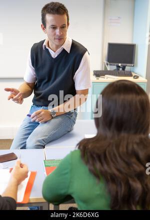 Adult Education: Teacher tuition. A class teacher giving some individual advice to a mature student. From a series of related images on the subject. Stock Photo