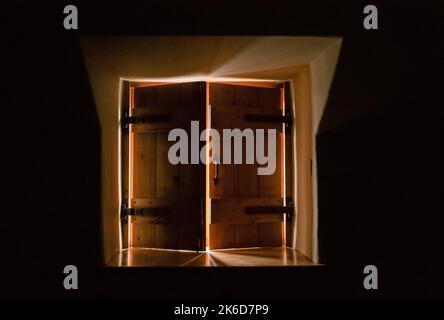 light spilling through two wooden window shutters Stock Photo