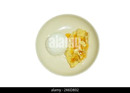 crispy Thai egg omelet stuffed chop pork dressing chili sauce topping on plain rice in white background Stock Photo
