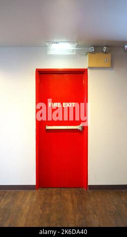Emergency fire exit door and red color and white wall in building. Stock Photo