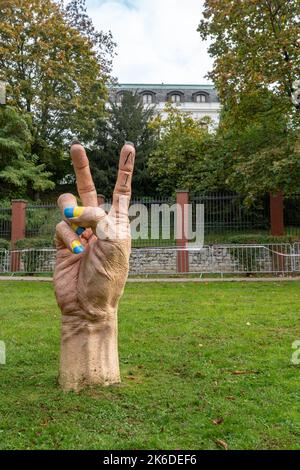 Public sculpture - hand with nails in Ukrainian colors, with a heroic 'V' gesture, pointed towards Russian embassy in Prague. Work of Jan Slovenčík. Stock Photo
